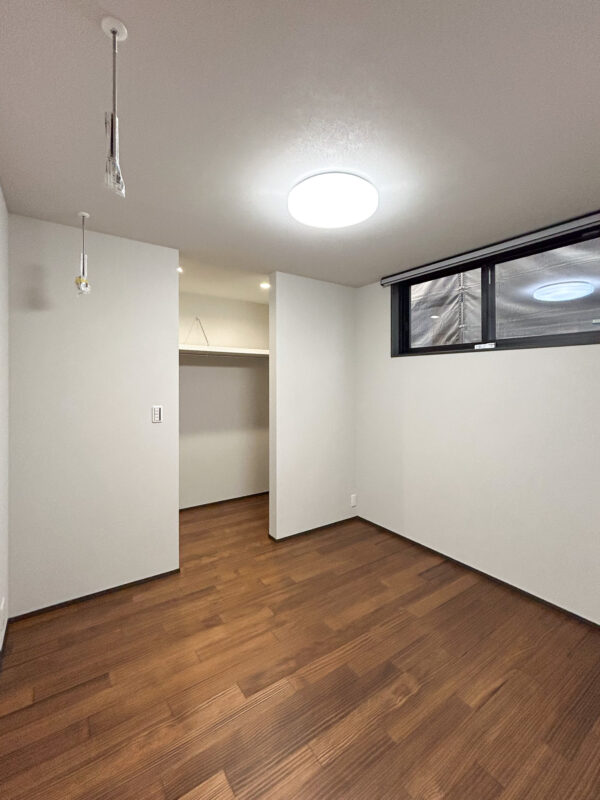 扉の無いウォークインクローゼットを備えた主寝室